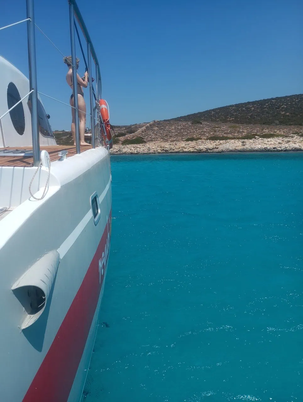 Photo of the Regaki Catamaran with passengers enjoying the sea on a sunny day, showcasing a memorable trip